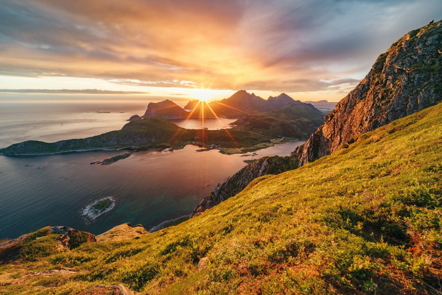 Photo by Daniel Seßler The sun is setting over a grassy hill